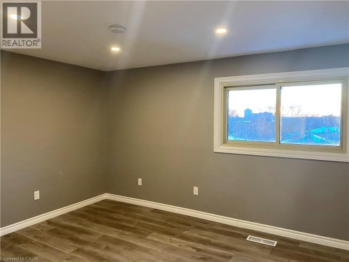 Spare room featuring recessed lighting, wood finished floors, and a smoke detector