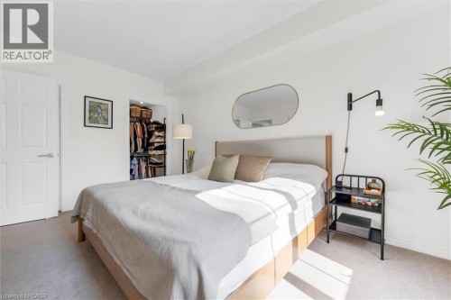 Spacious sun-filled south-facing primary bedroom with walk-in closet and private bathroom