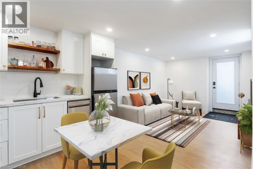 Living area with light wood-style floors and recessed lighting