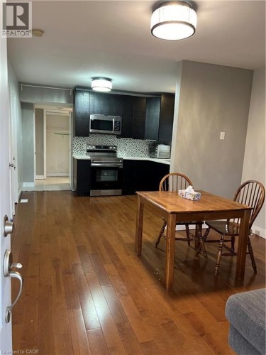 Open-concept living space with wood-finish flooring extending throughout