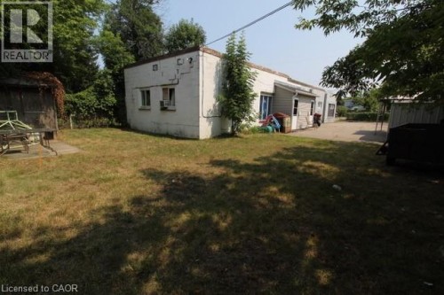 Back of property featuring a yard and a patio