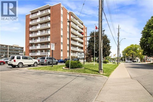 Brick facade building with multiple levels of white-railed balconies