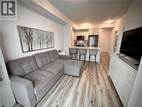 Open-concept living area featuring wood-finish flooring