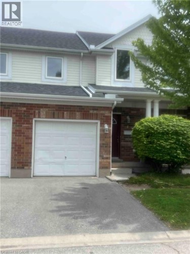 Brick and siding exterior featuring a single-car garage with an asphalt driveway