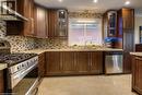 Spacious kitchen with stainless steel appliances and tile floor