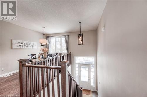 Staircase with wood-type flooring and a textured ceiling