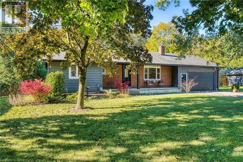 View of front of property featuring a garage and a front yard