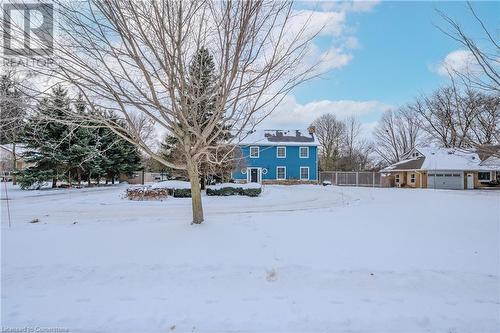 View of front yard covered in snow.