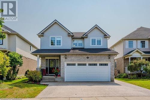 Craftsman inspired home with a garage and a front yard