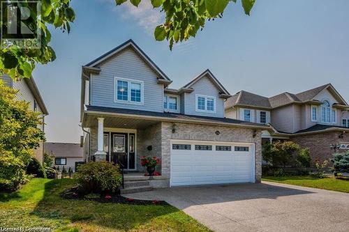 View of front of property featuring a porch and a garage