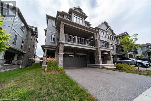 View of front of property with a garage and a front lawn