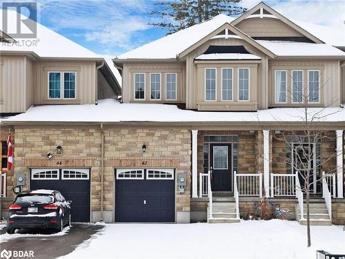 View of front facade with covered porch and a garage