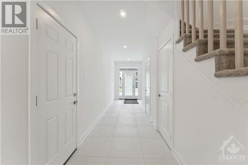 Spacious foyer with storage closet under staircase