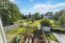 Fenced backyard w view of pathway