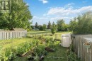 Fenced backyard w view of pathway