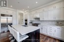 Huge granite island in Chef's kitchen