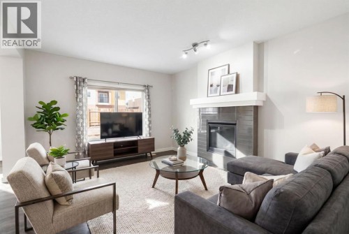 Bright, open living room with gas fireplace - virtually staged